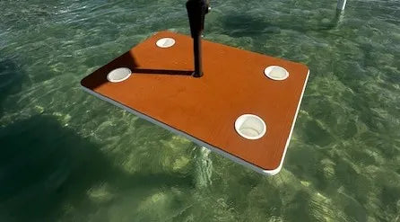 he Admiral tiki table on the water — premium coastal outdoor furniture